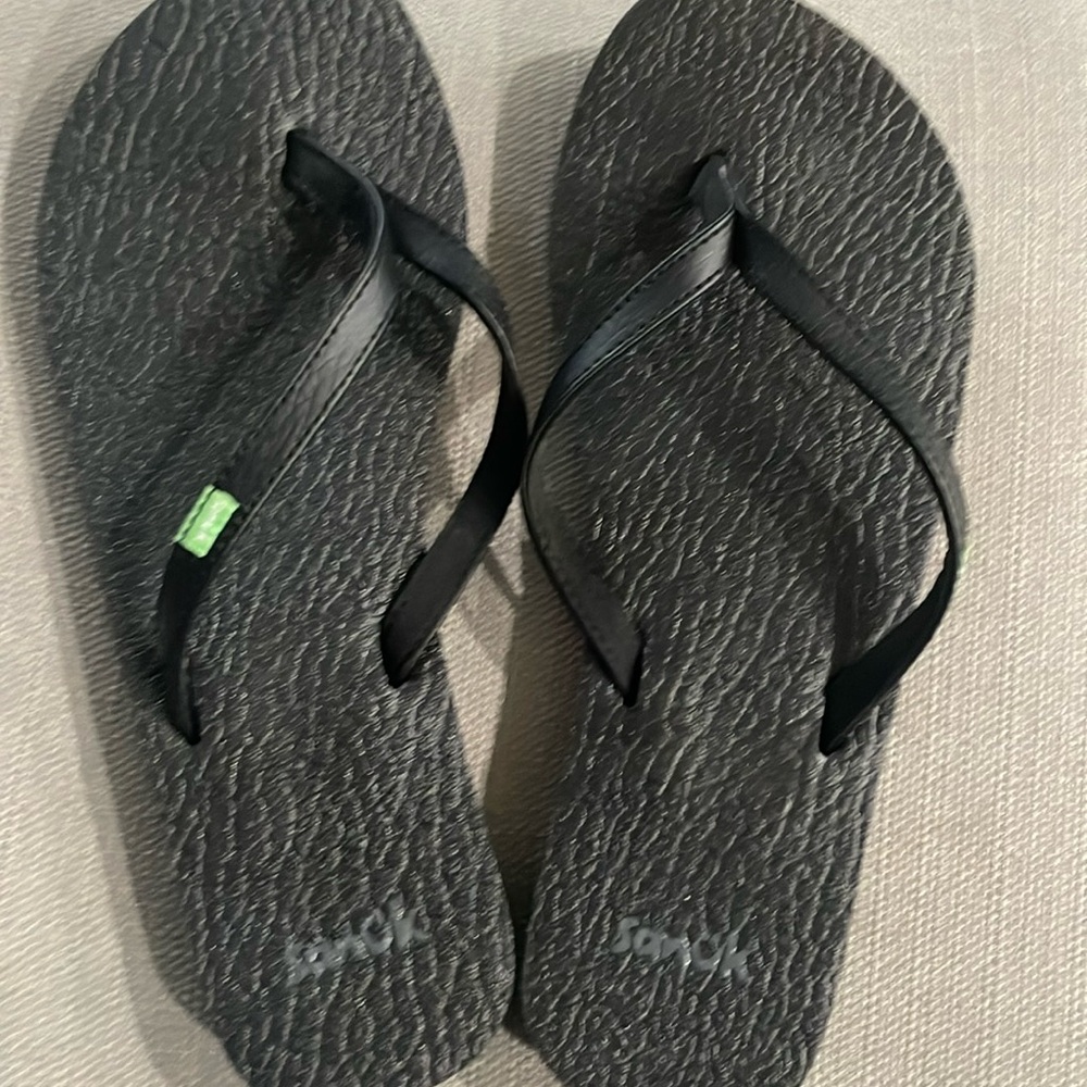 Black Sanuk flip flops